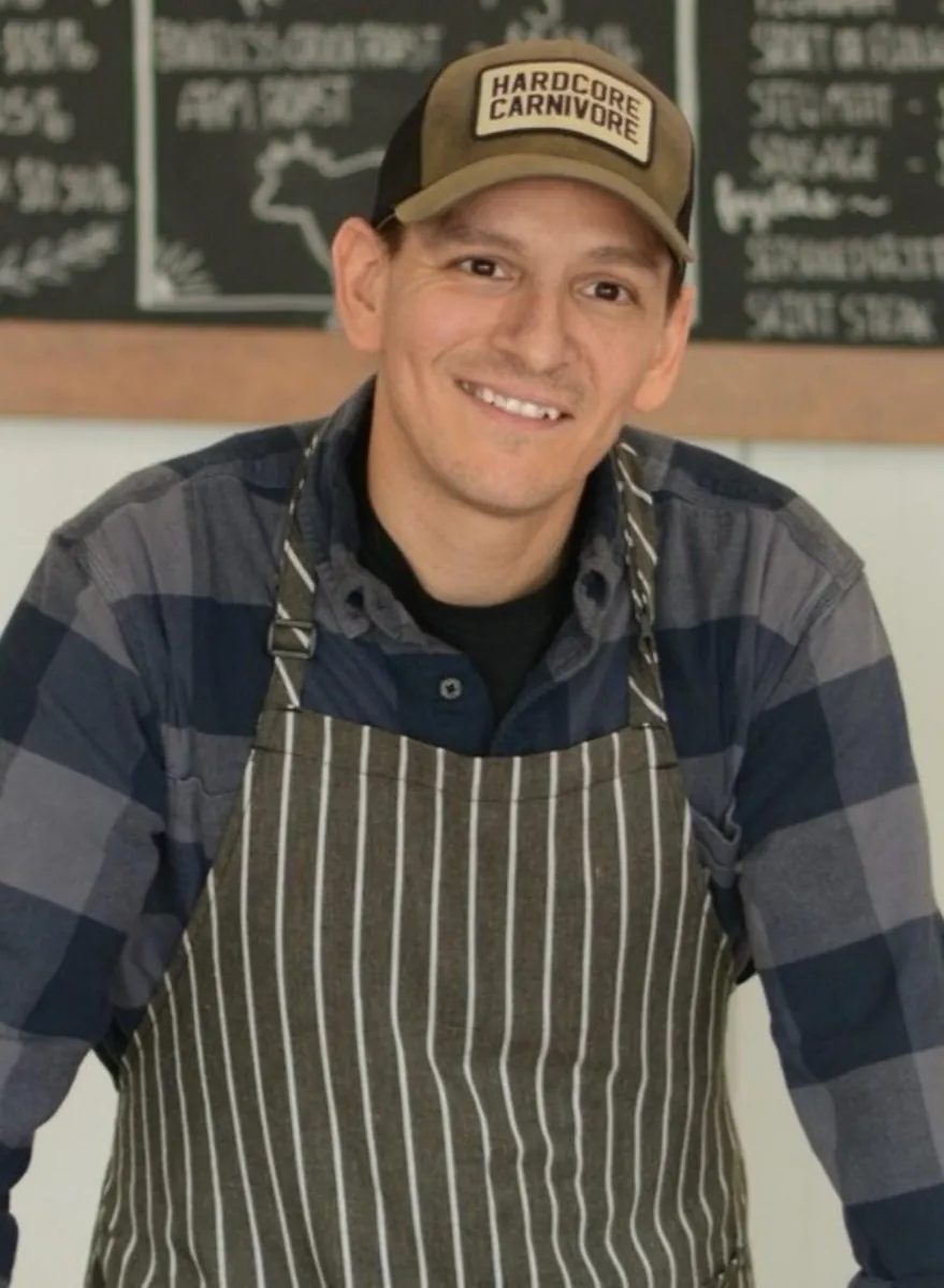 Ron Jimenez in butcher's apron at the Central Texas processing facility — founder of Ranch Hand Rendering