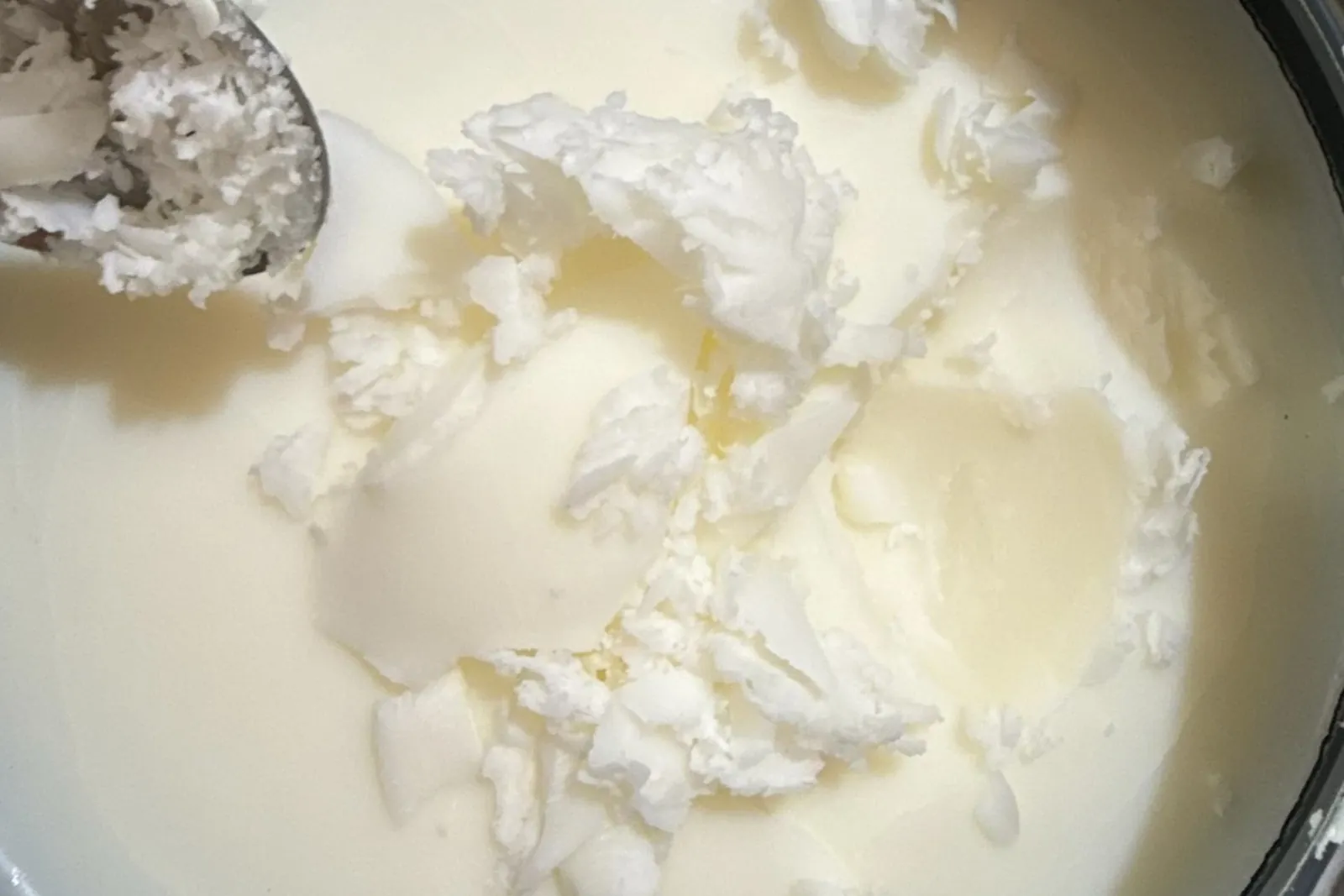 Cosmetic-grade beef tallow being scooped for skincare formulation, Ranch Hand Rendering, Central Texas