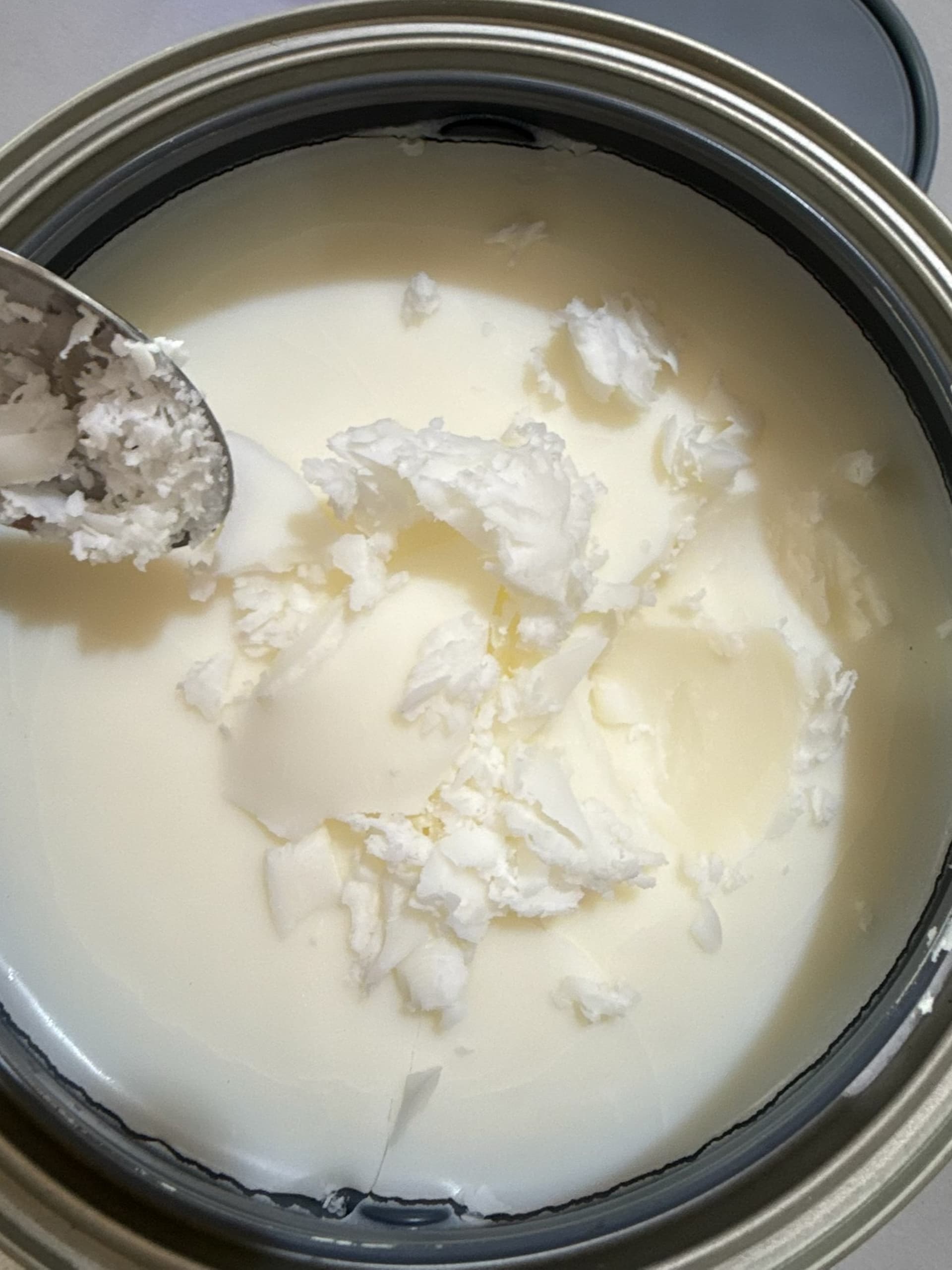 Formulation grade tallow being scooped for cosmetic use