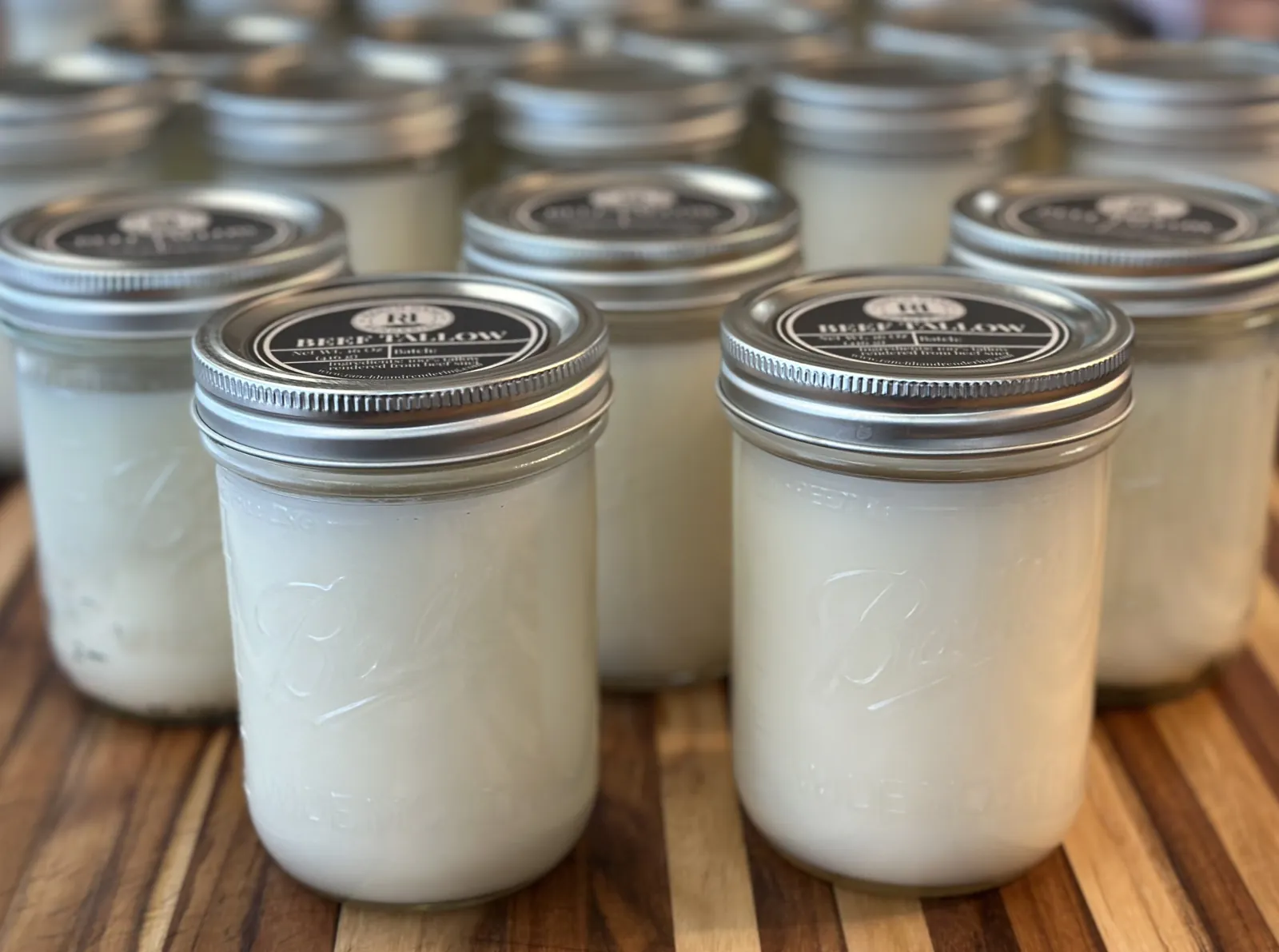 Jars of Ranch Hand Rendering beef tallow, a stable, ancestral alternative to seed oils for home cooking